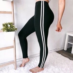 Black leggings with two white stripes.